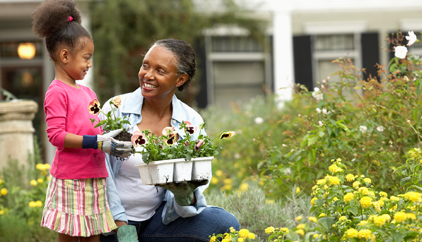A grandma and young granddaughter gardening. While getting older comes with many joys, it also has leak-related challenges.