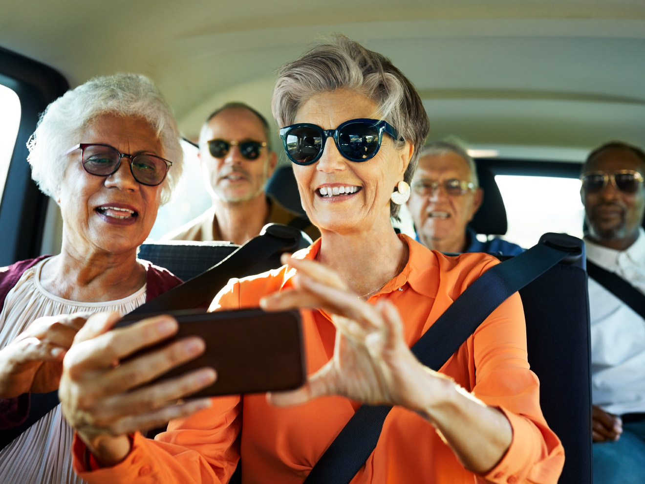 Two women take a selfie in a van. Car trips are a breeze with the right planning, so you can enjoy the road without worry.