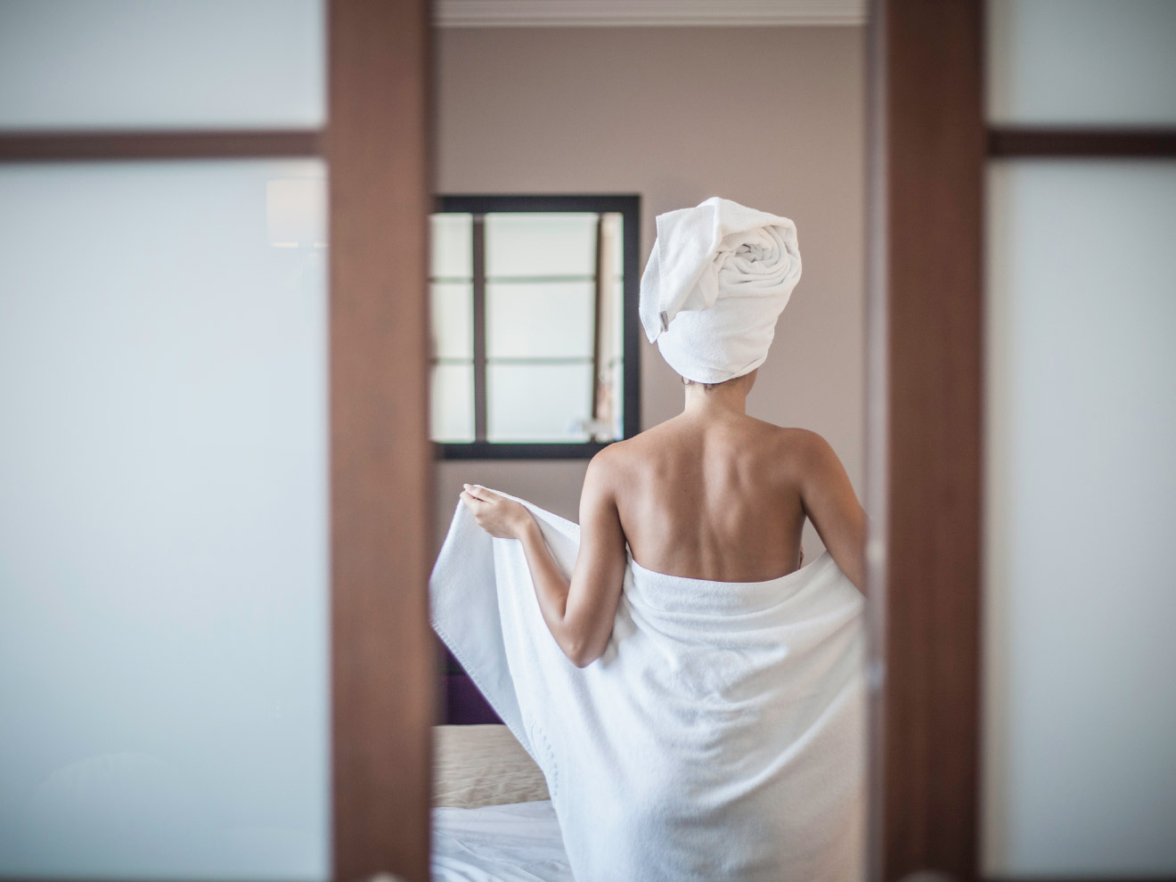 A woman wraps herself in a towel. As your largest organ, maintaining your skin's pH balance is vital for its health and yours. 